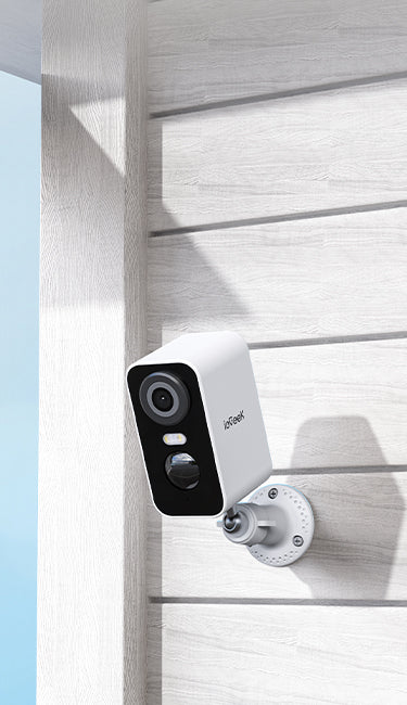 ieGeek smart home battery-powerd security camera named ZY-C1 mounted on a wooden wall with a clear blue sky.